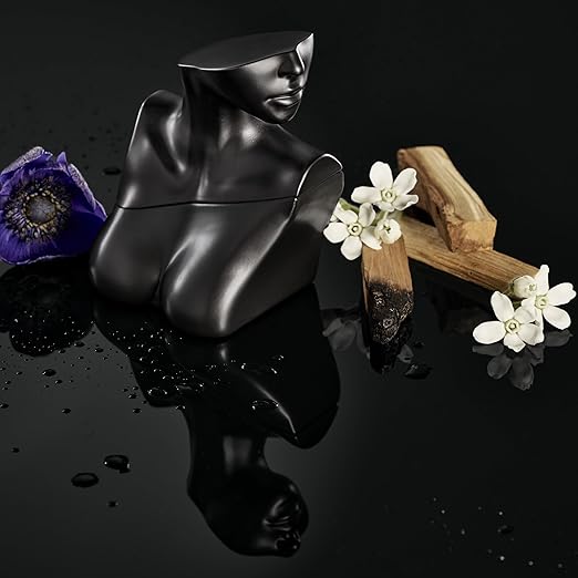 Black artistic figure with flowers on a reflective black surface