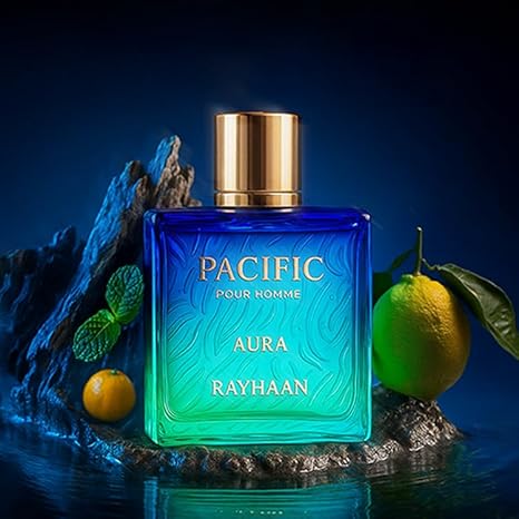 Blue perfume bottle labeled 'Pacific Aura Rayhaan' with gold cap on a dark background
