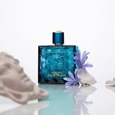 Blue perfume bottle with decorative elements on a reflective surface