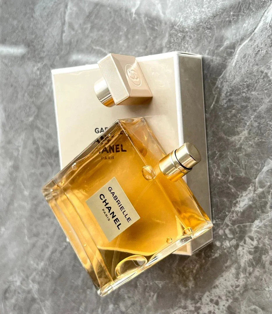 Chanel perfume bottle and packaging on a gray marble surface