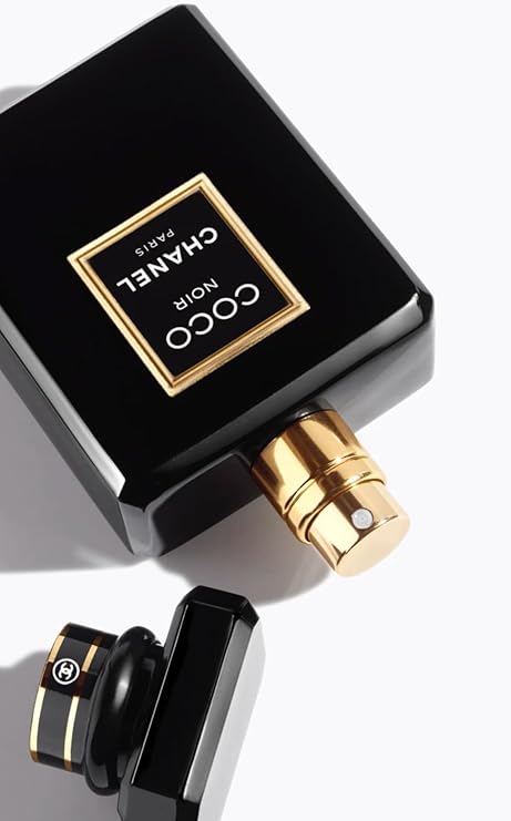 Close-up of a Chanel perfume bottle with gold cap on a white background
