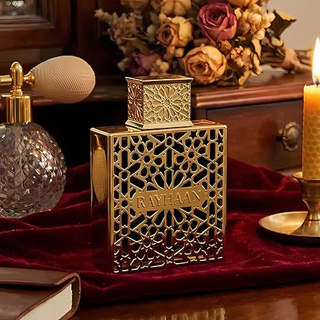 Decorative gold bottle with intricate design on a red fabric background
