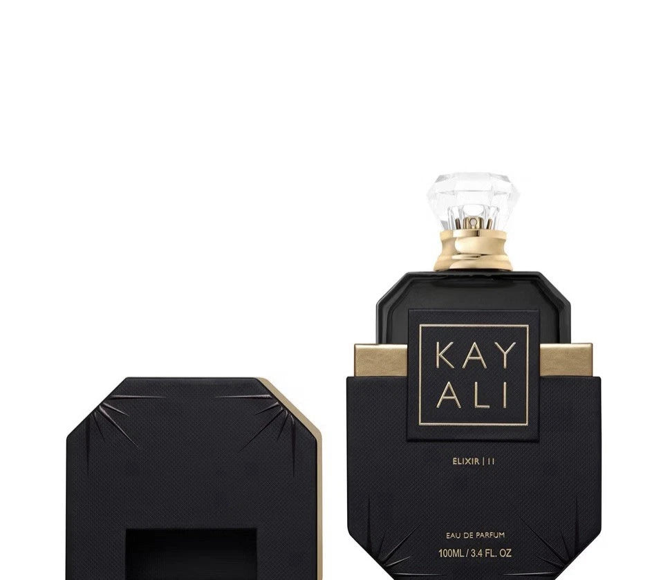 KAYALI Blusher 111 Eau de Parfum bottle in black with gold accents and a clear faceted cap, shown next to its matching black and gold box on a white background.