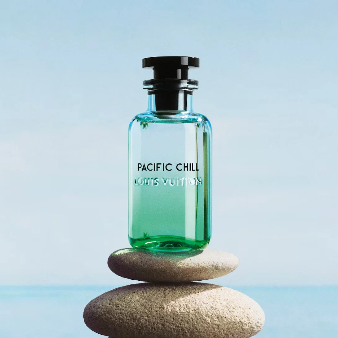 Louis Vuitton Pacific Chill perfume bottle on a stone with a blue background