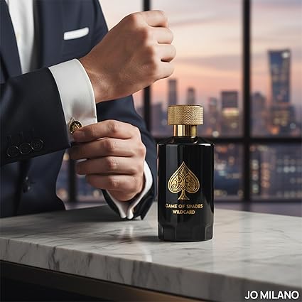 Man in suit holding a black and gold perfume bottle with cityscape in the background