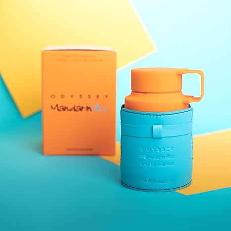 Orange mug with blue sleeve and Odyssey Mandarin box on a colorful background