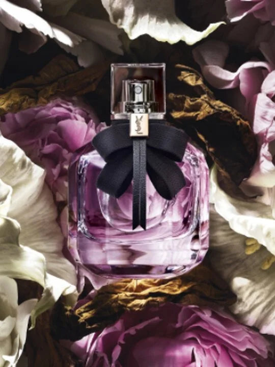 Perfume bottle with a black bow on flowers