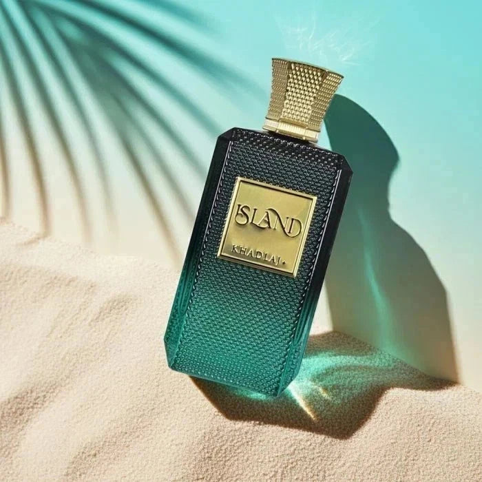Perfume bottle with gold cap and 'ISLAND' branding on a textured surface with light blue gradient background