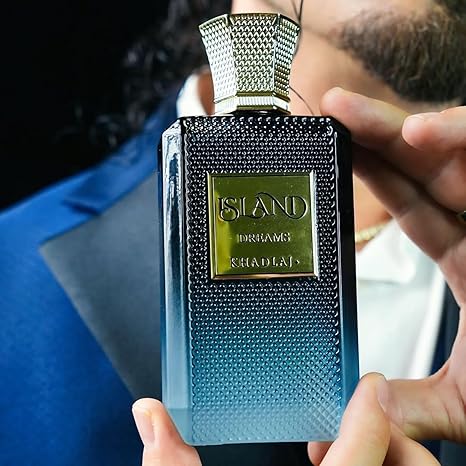 Person holding a textured perfume bottle with 'Sland' branding.