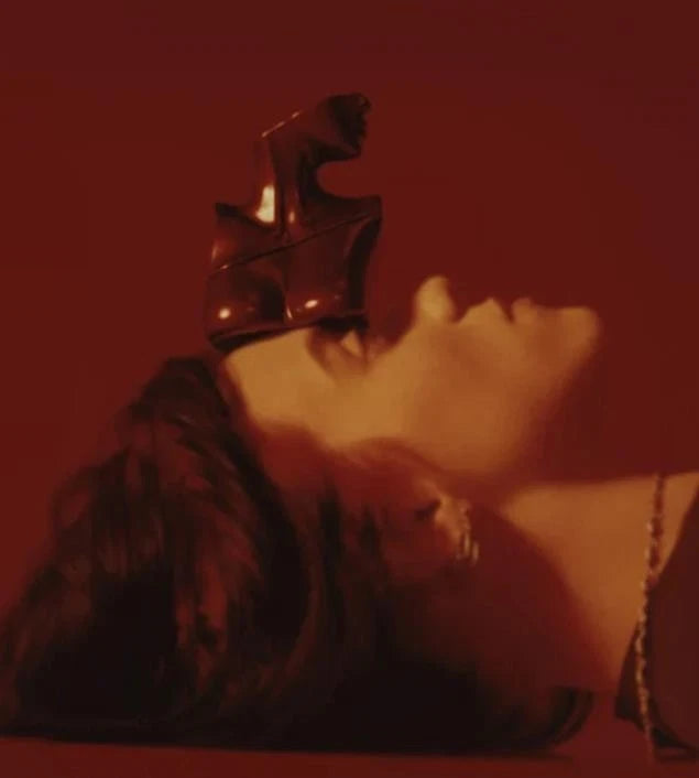 Person wearing a crown with a red filter applied