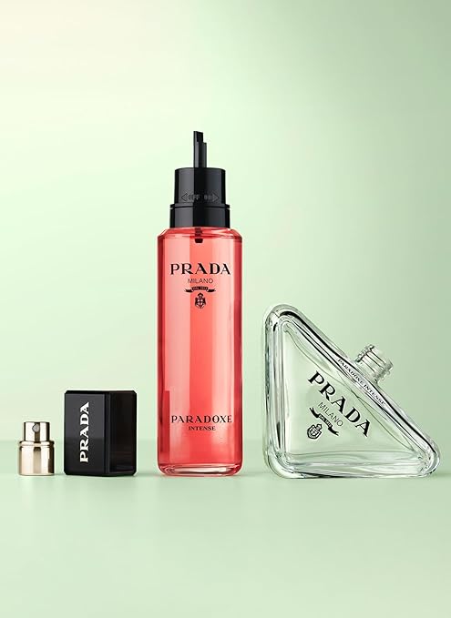 Prada perfume bottle and packaging on a light green background