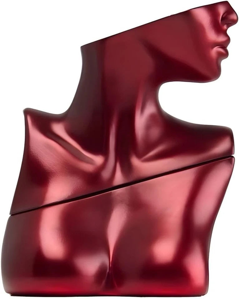 Red, abstract sculpture resembling a face on a white background