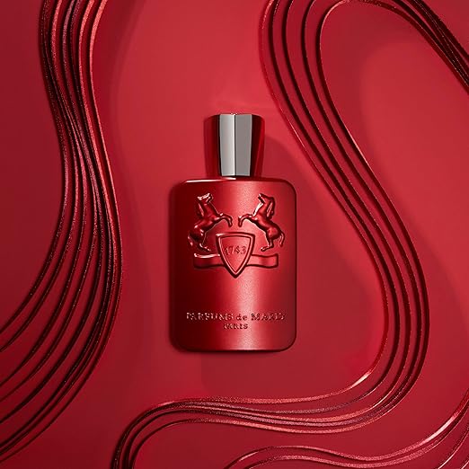 Red perfume bottle with silver cap on a red background