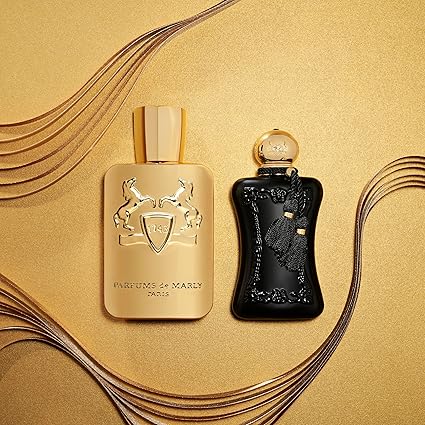 Two perfume bottles, one gold and one black, on a gold background with decorative elements.