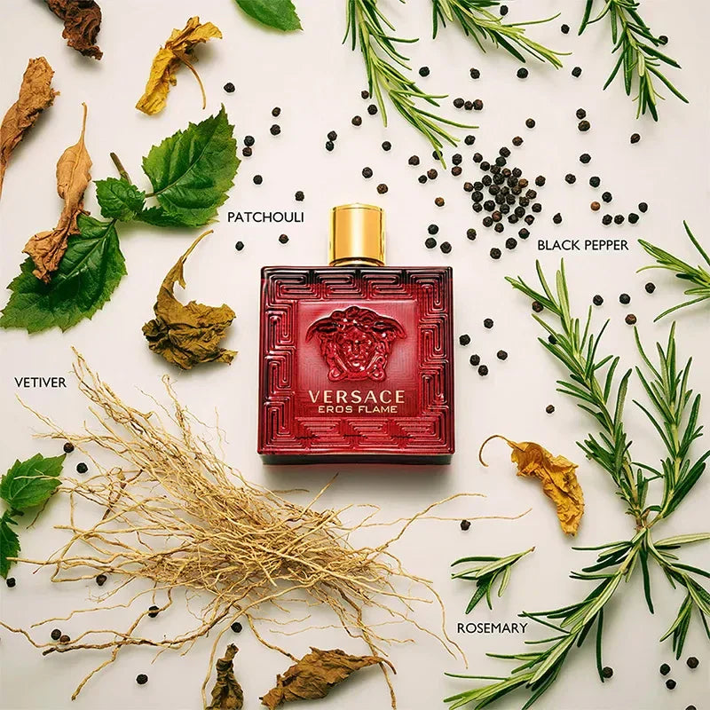 Versace perfume bottle surrounded by herbs and spices on a white background