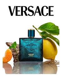 Versace perfume bottle with lemons and oranges on a reflective surface