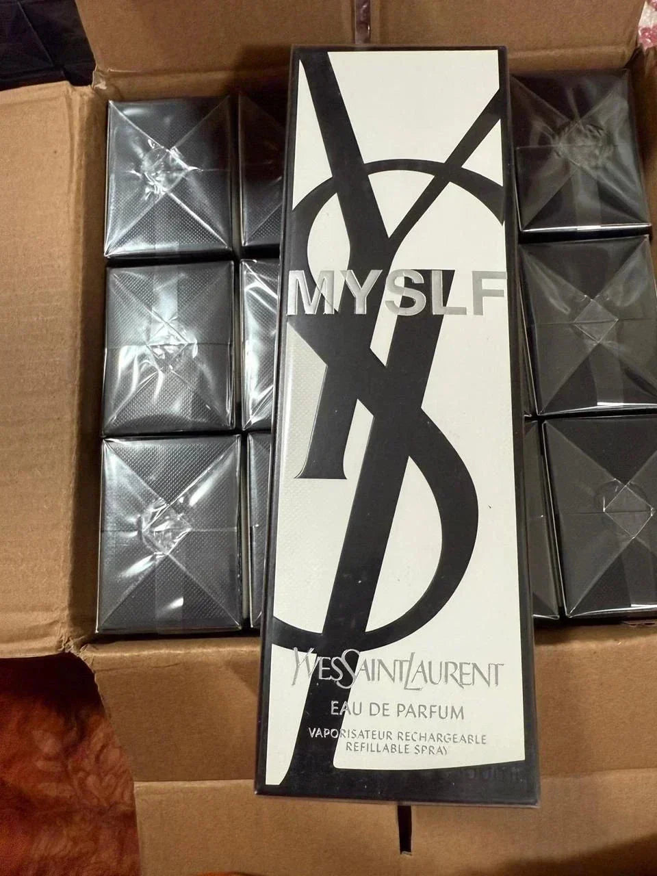 Yves Saint Laurent perfume box with 'MYSLF' branding on a cardboard surface